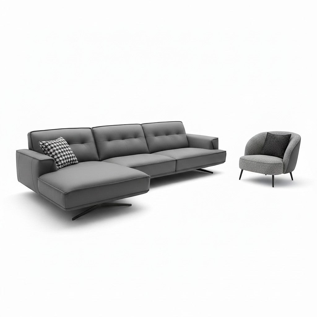 Ambrosia Concepts grey faux leather L-shaped sectional sofa with chaise and matching armchair, featuring tufted cushions and piping detail.