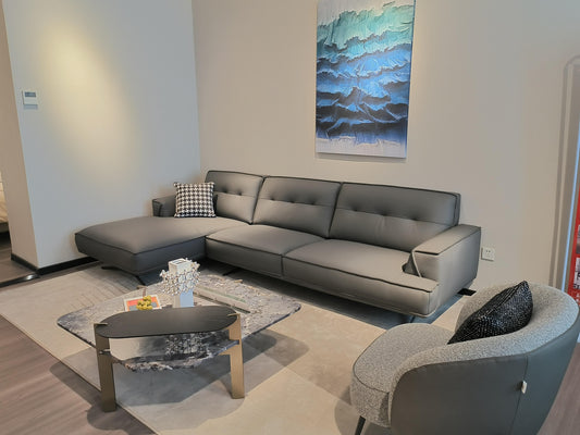 Ambrosia Concepts grey leather L-shaped sectional sofa with chaise lounge and tufted cushions.
