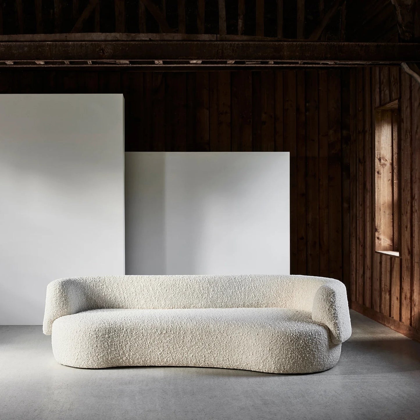 Ambrosia Concepts Angola 3-seater sofa in ivory boucle fabric with curved design and solid wood frame.