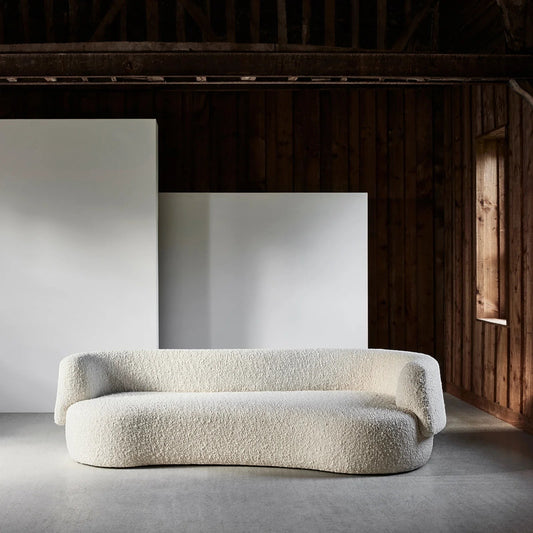 Ambrosia Concepts Angola 3-seater sofa in ivory boucle fabric with curved design and solid wood frame.