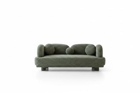 Ambrosia Concepts Casper 3-seater sofa in heavy green boucle fabric with rounded arms and decorative ball cushions.