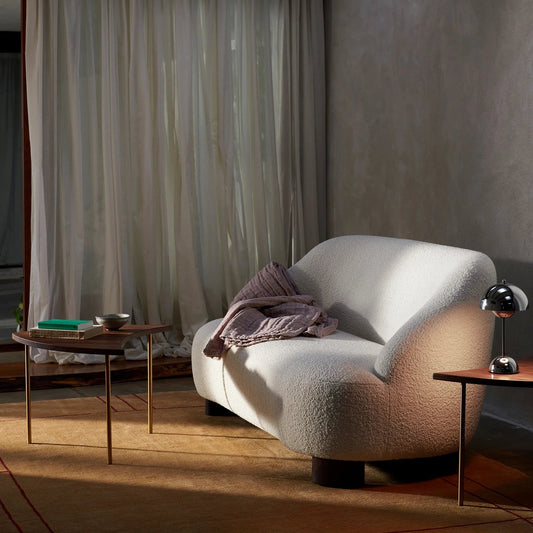 Ambrosia Concepts CB Sofa 2 Seater in cream boucle fabric with curved silhouette and dark wood legs. A pink throw is draped over the armrest.