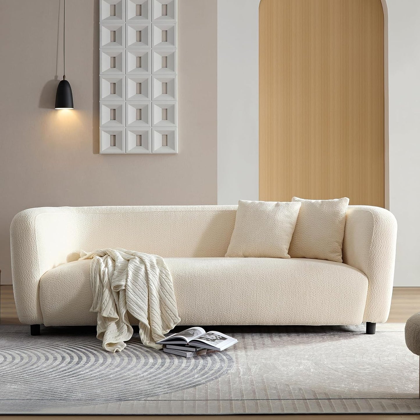 Ambrosia Concepts Symphony 3-seater sofa in cream boucle fabric with curved silhouette and plush cushioning. Includes throw blanket and pillows.