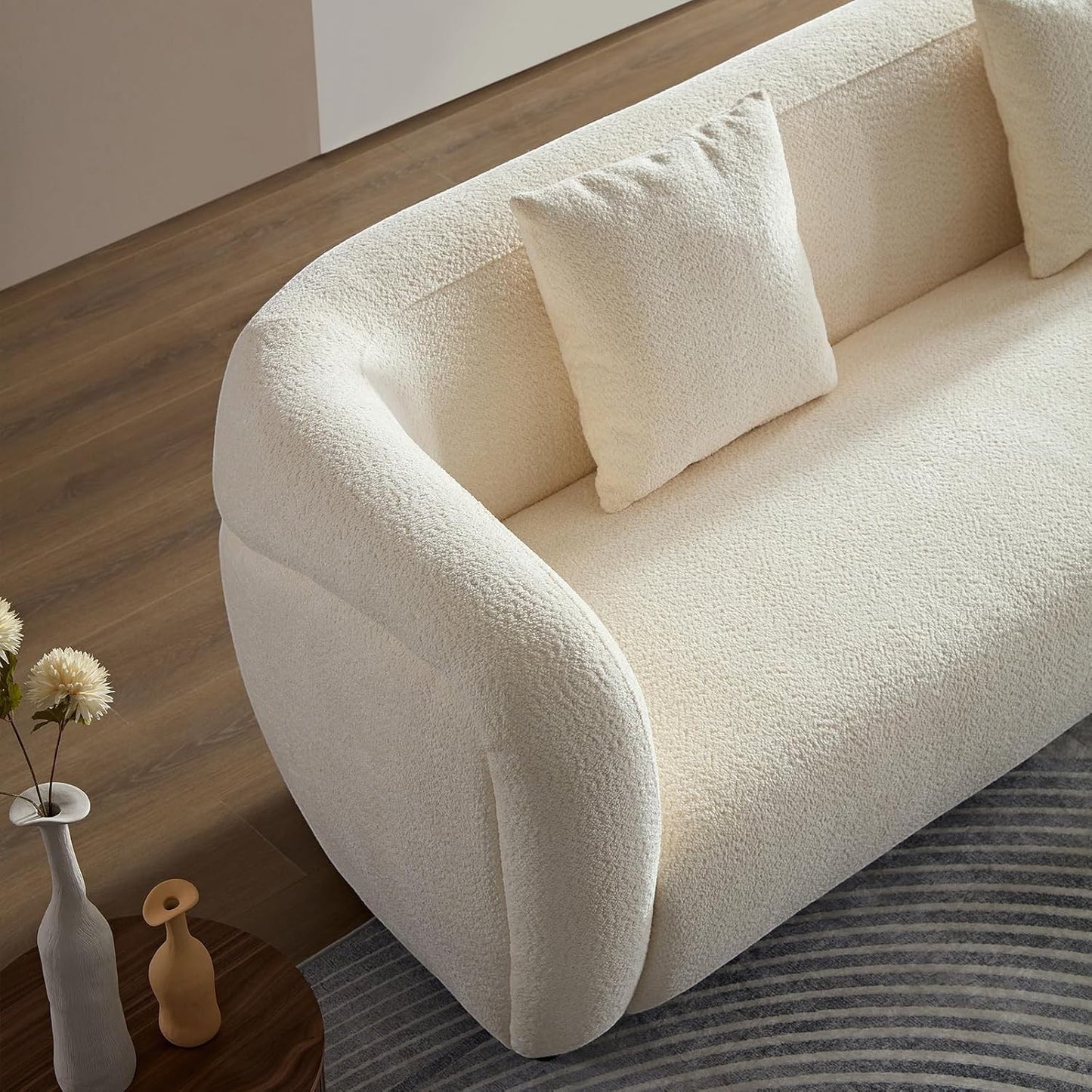Ambrosia Concepts Symphony 3-seater sofa in cream boucle fabric with curved silhouette and plush cushioning.