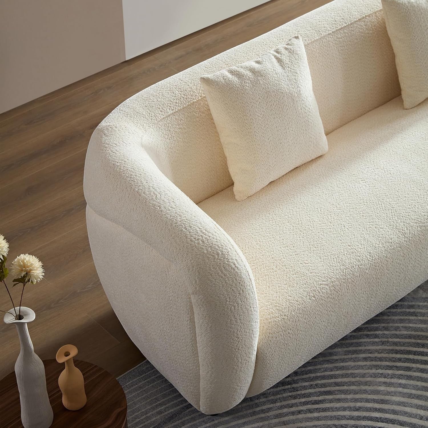 Ambrosia Concepts Symphony 3-seater sofa in cream boucle fabric with curved silhouette and plush cushioning.
