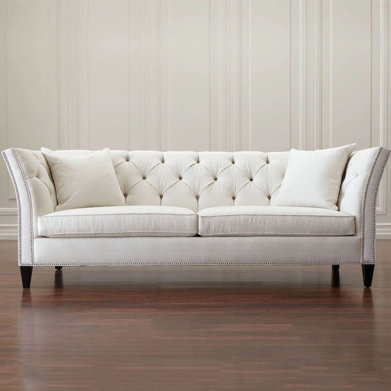 Ambrosia Concepts Old Trafford 3 Seater Sofa in neutral fabric with tufted back, nailhead trim, and plush cushions.